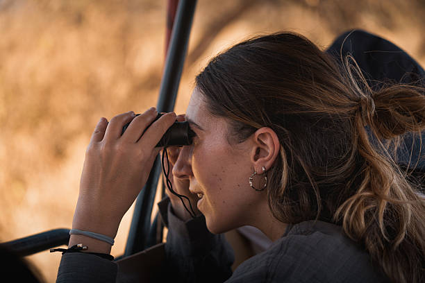 Young woman enjoying a birding safari experience in tarangire national park, tanzania