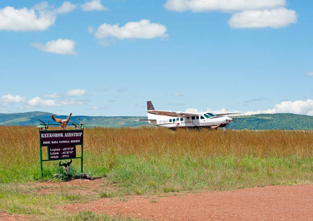 Kerokok Airstrip in Masai Mara Keekorok airstrip, Masai Mara National Park, Kenya, Africa. Turboprop Aircraft taking off from the remote bush airstrip of Keekorok in the Masai Mara National Park. Medium and Light aircraft are the best way to access safari and wildlife reserve areas in the Mara.
