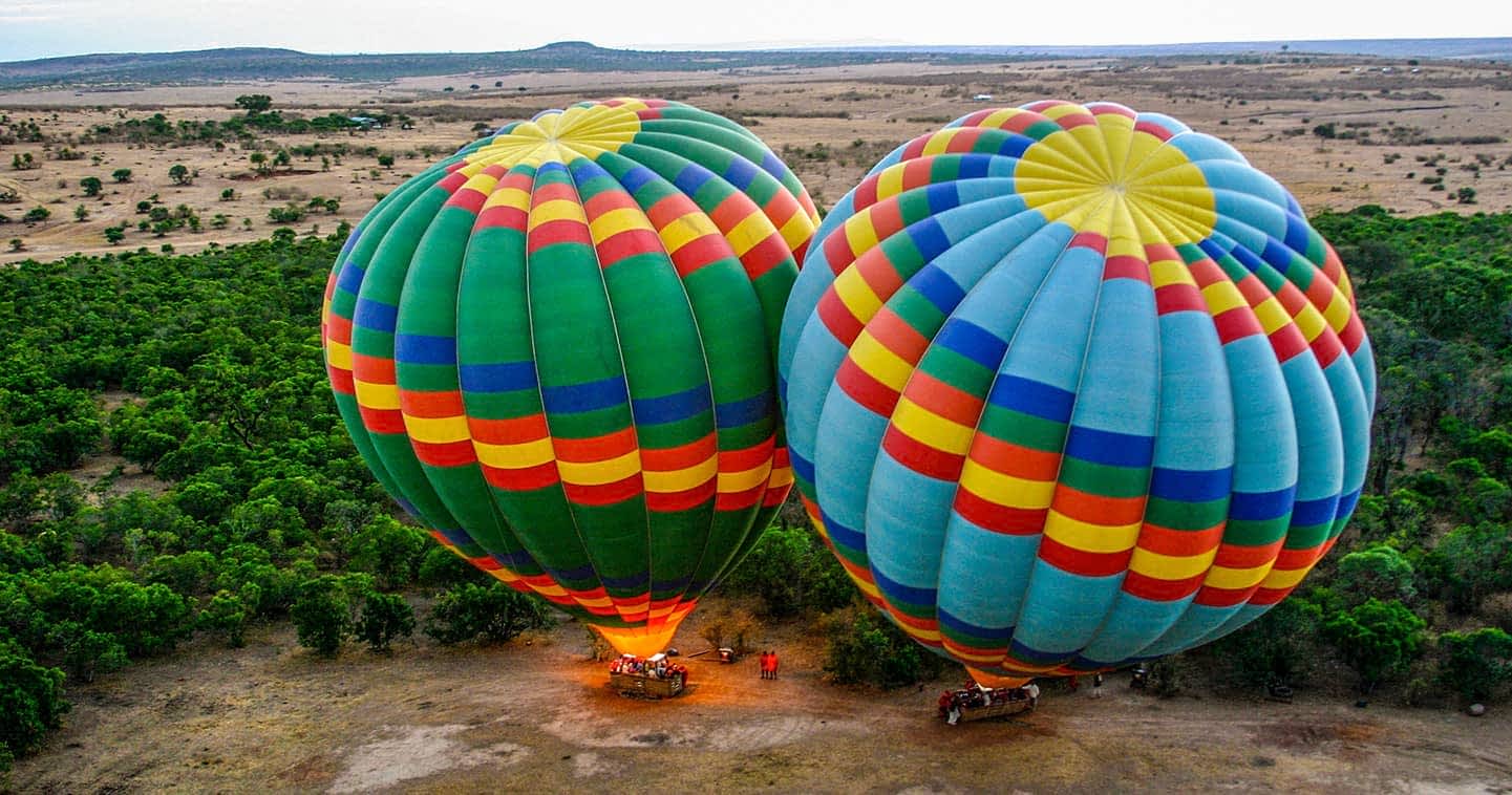 Two hot air balloons preparing to fly in Masai Mara