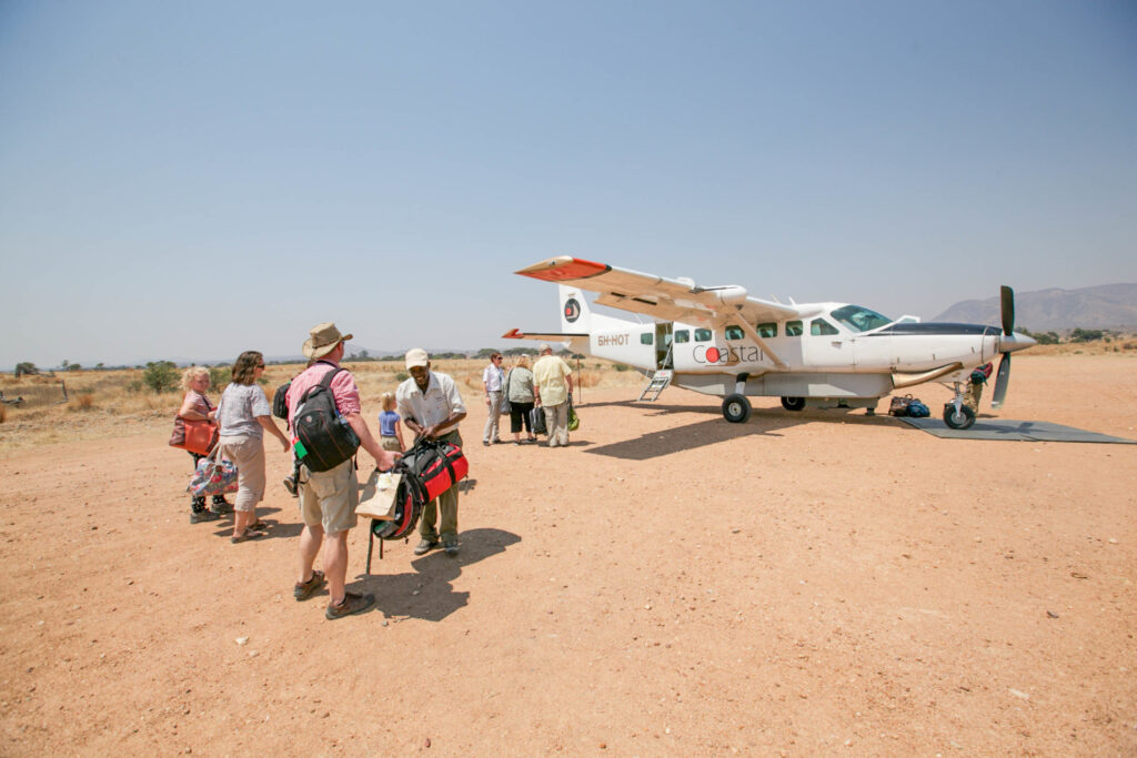 A family boarding a Tanzania Coastal Aviation plane from Serengeti to Zanzibar