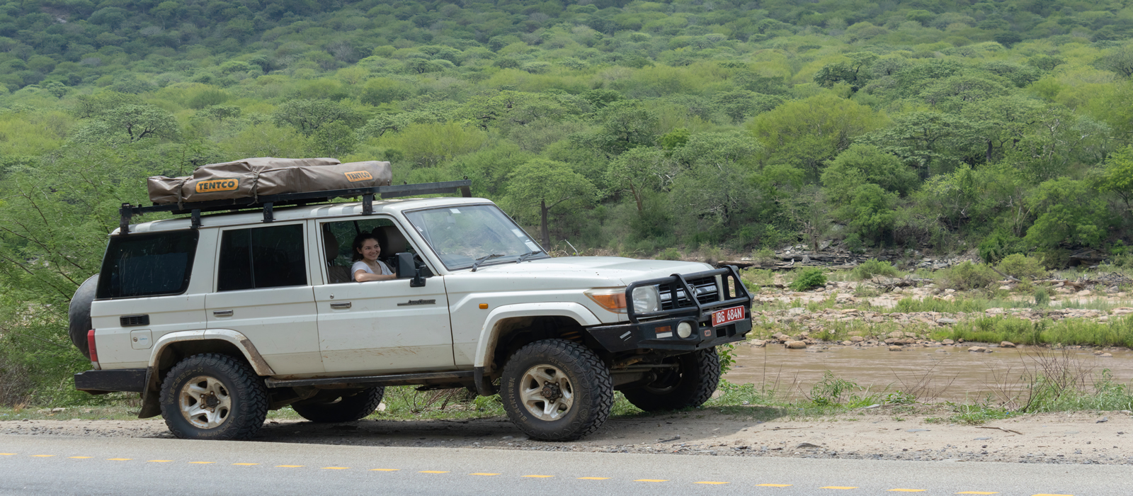 A woman in a landcruiser during a self drive overland safari in East Africa